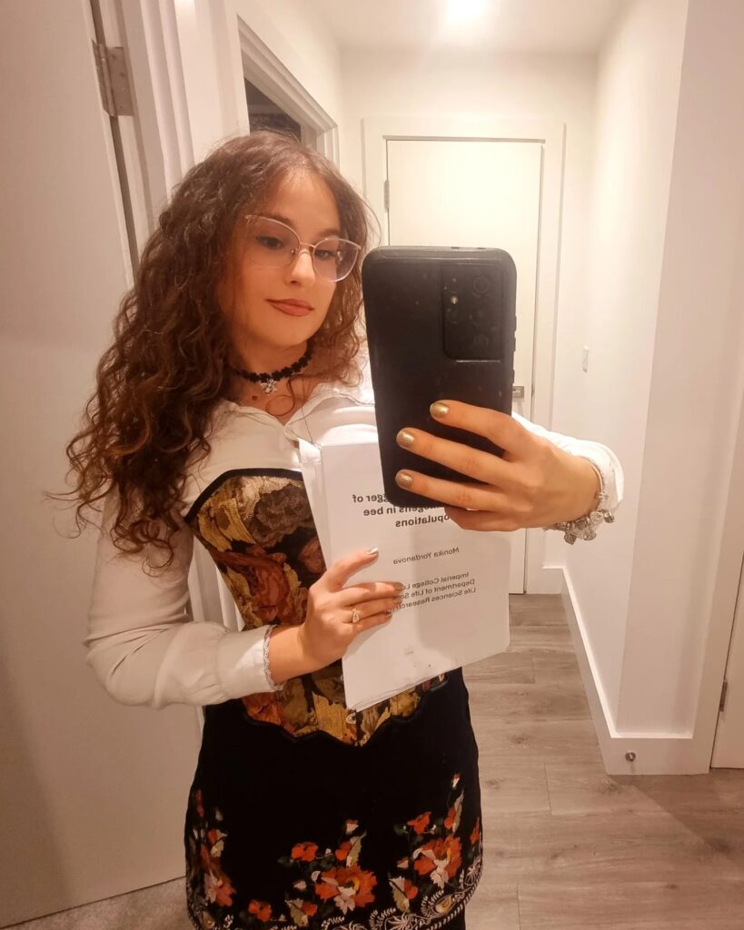Monika Yordanova holding a print of her PhD Thesis